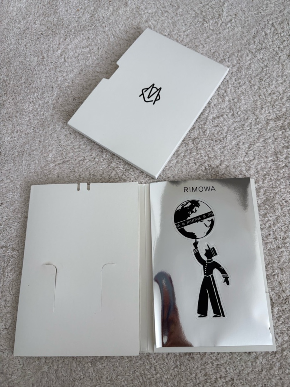 RIMOWA Silver Logo Sticker Card with Black Graphic and folio